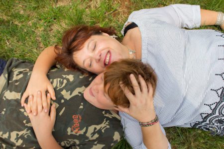 Mother and son laughing together during lifestyle family photo session